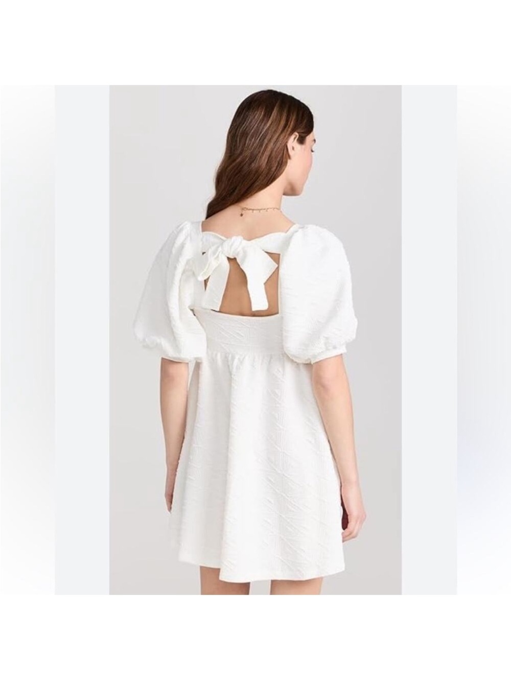 Free People Violet Mini Dress features texture matelasse fabric tie-back detail.